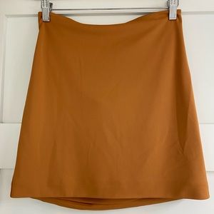 NOT YOURS TO KEEP NWOT brown skirt with open low back area. Size Small Brown